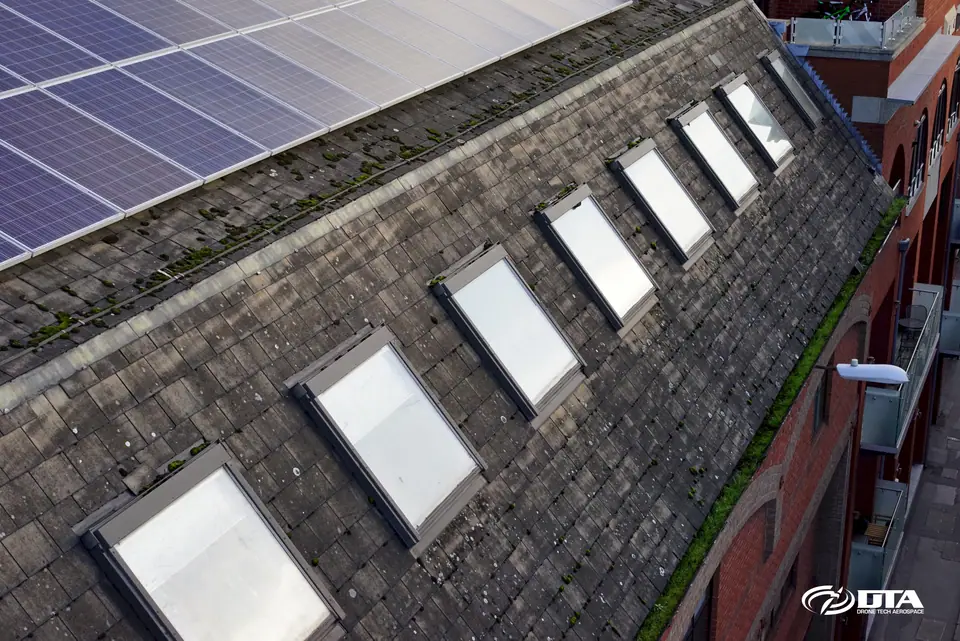 Drone roof inspection of a public building showing slate detail and rooflights